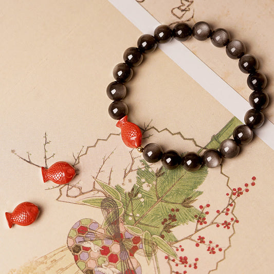Pulsera protectora calmante con piedras de Buda, obsidiana, cinabrio y pez koi con brillo plateado natural