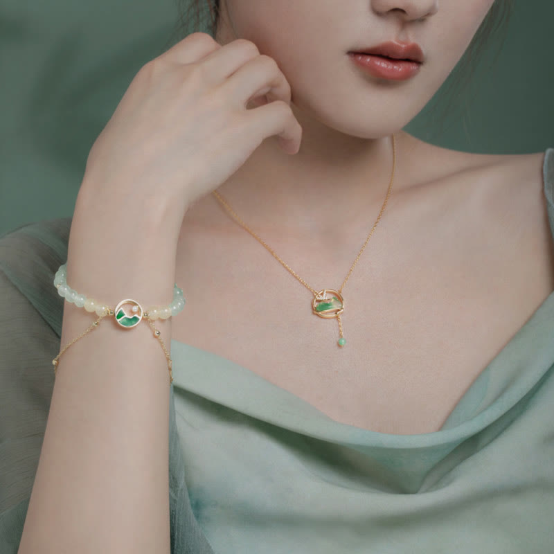 Conjunto de collar y pulsera con colgante de la suerte, piedras de Buda, cobre bañado en oro de 18 quilates, jade natural y calcedonia. Un panorama de ríos y montañas.