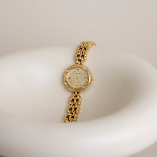 Reloj vintage Lancel redondo dorado con pavé
