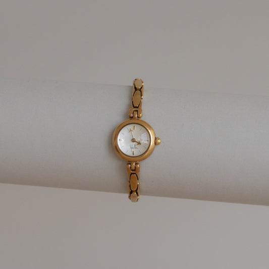 Reloj vintage Sybilla delgado y redondo de oro