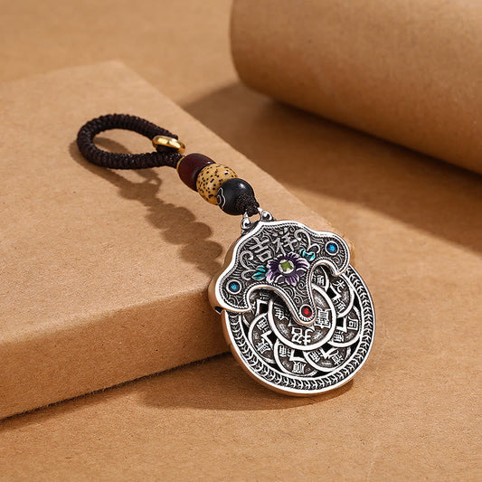 Llavero con moneda de cobre y flor de peonía de Buda, que representa la riqueza auspiciosa.