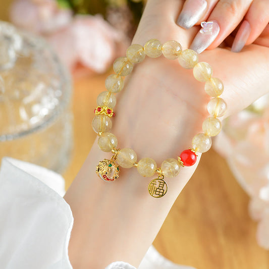 Pulsera de la riqueza con abalorio de campana de cuarzo rutilado dorado natural de Buda