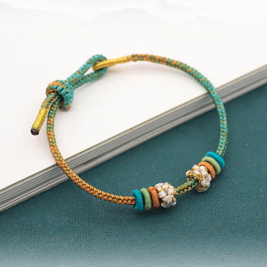 Pulsera trenzada de ocho hilos con nudo de la paz y flor de durazno, hecha a mano con piedras de Buda