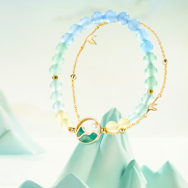 Conjunto de collar y pulsera con colgante de la suerte, piedras de Buda, cobre bañado en oro de 18 quilates, jade natural y calcedonia. Un panorama de ríos y montañas.