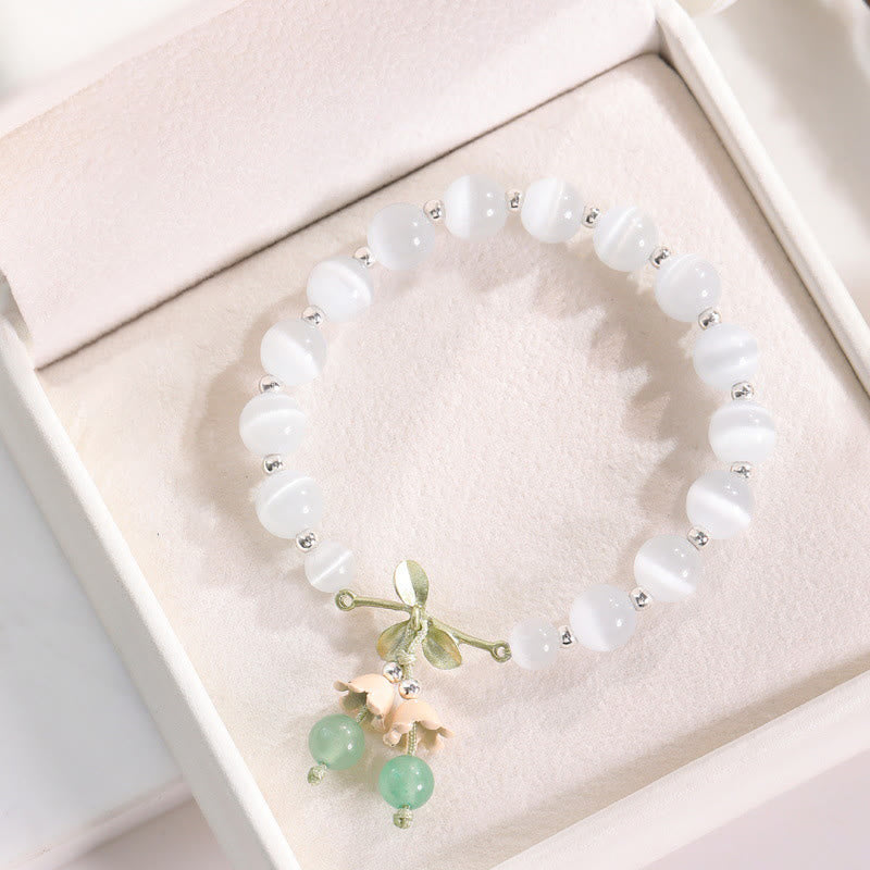 Pulsera con dijes de orquídea de la paz, calcedonia azul, aventurina verde y ojo de gato de Buda