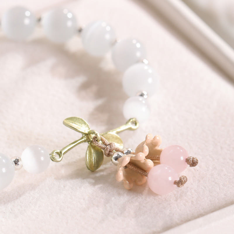 Pulsera con dijes de orquídea de la paz, calcedonia azul, aventurina verde y ojo de gato de Buda