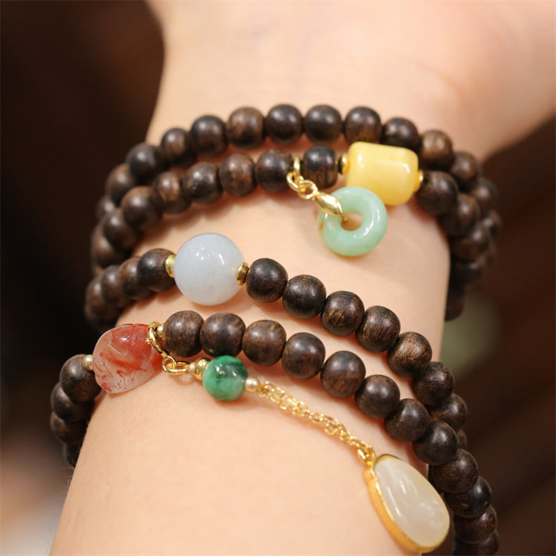 Pulsera de la paz con 108 cuentas de mala de Buda, madera de agar de Brunei, ámbar, ágata roja y jade con hebilla de la paz.