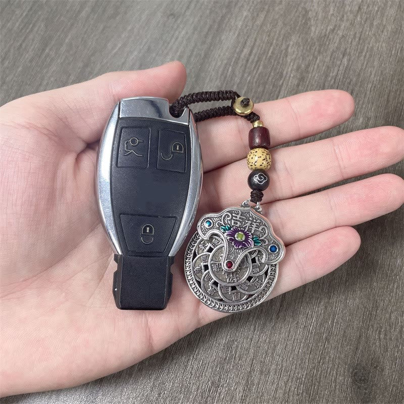 Llavero con moneda de cobre y flor de peonía de Buda, que representa la riqueza auspiciosa.