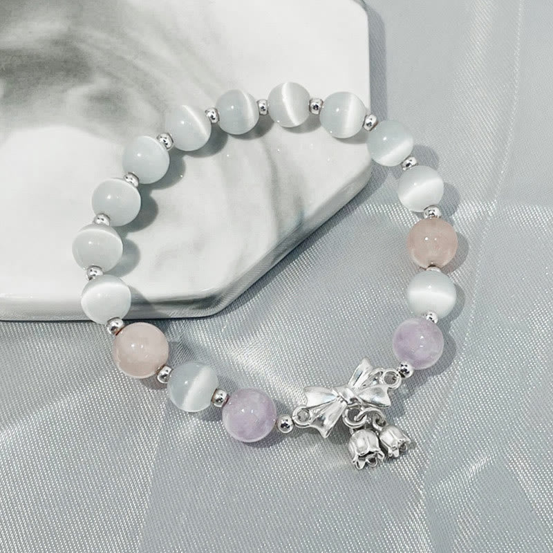 Pulsera con dije de roseta de amatista y lavanda con ojo de gato y piedras de Buda