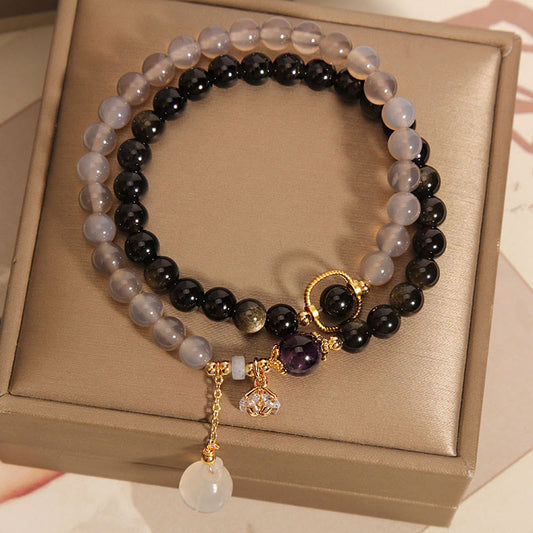 Pulsera de doble vuelta reforzada con dije de loto, obsidiana, ágata gris y brillo dorado de Buddha Stones