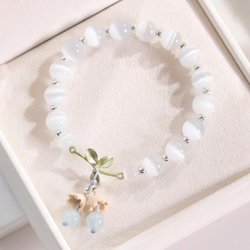 Pulsera con dijes de orquídea de la paz, calcedonia azul, aventurina verde y ojo de gato de Buda