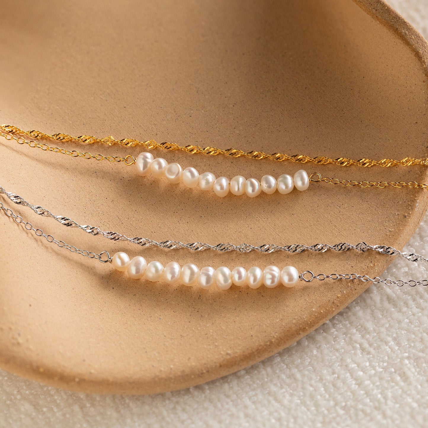 Pulsera trenzada de dos perlas