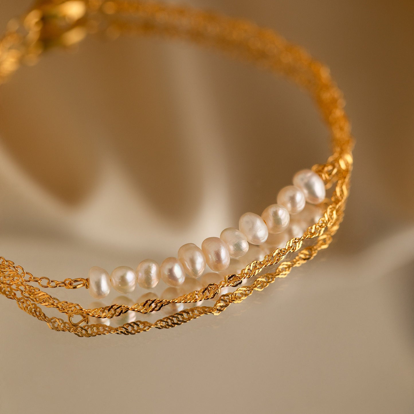 Pulsera trenzada de dos perlas