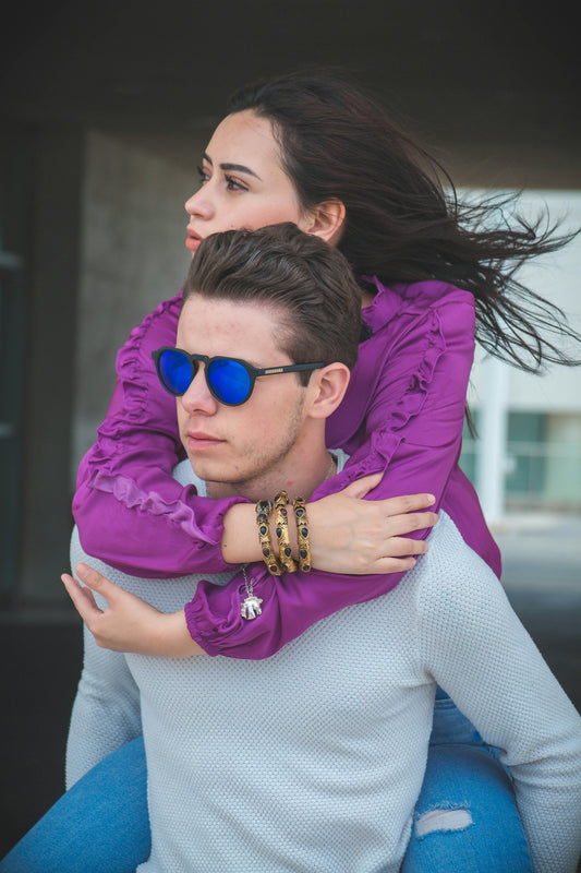 a man carrying a woman on his back