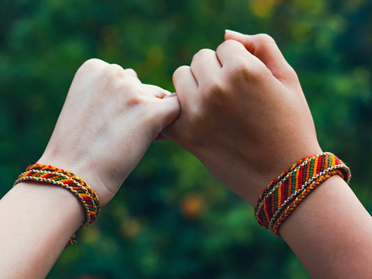 person wearing beaded bracelets and bracelet