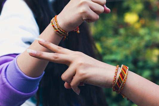 woman in blue shirt wearing gold bracelet