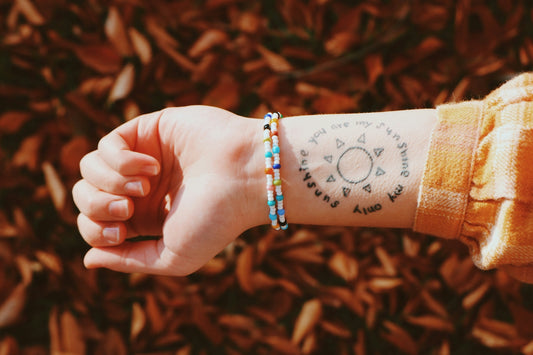 person wearing blue and silver bracelet
