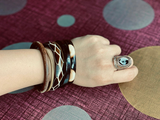 person wearing silver and black ring