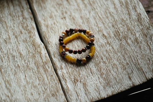 a beaded bracelet sitting on top of a wooden table