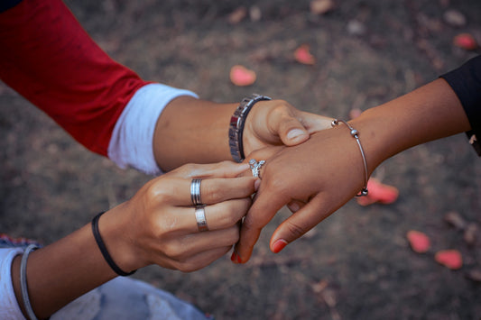a close up of two people holding hands