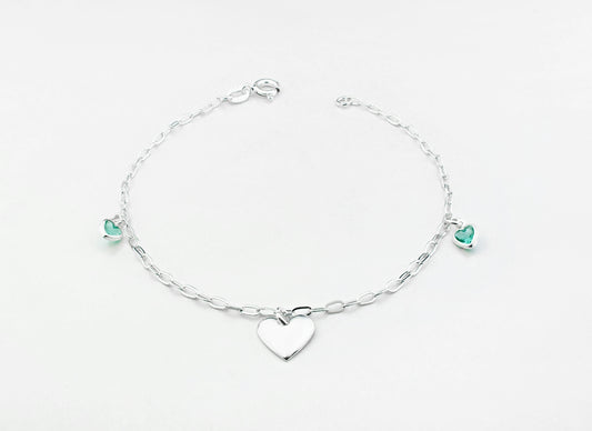 a silver bracelet with a heart charm