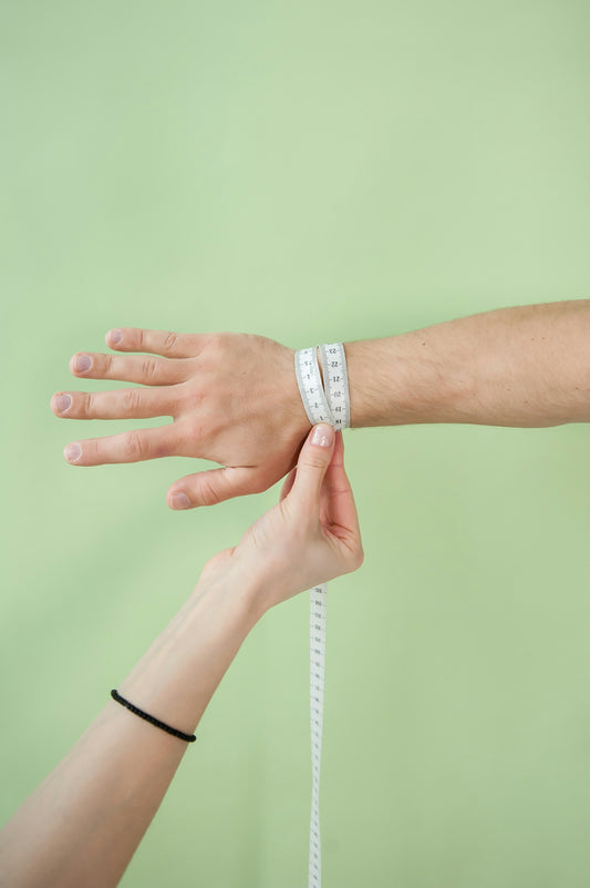 a person holding a measuring tape in their hand