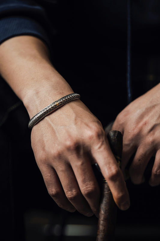 a man is holding a cigar in his hand