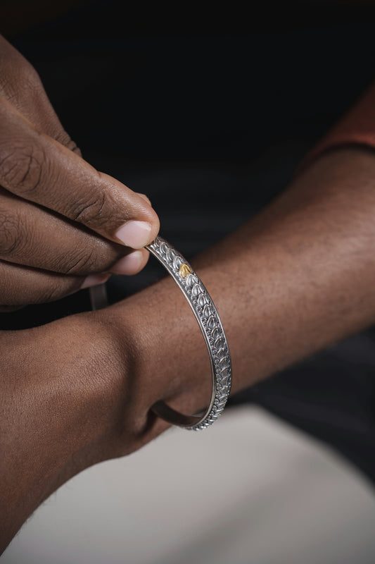 a close up of a person holding a bracelet