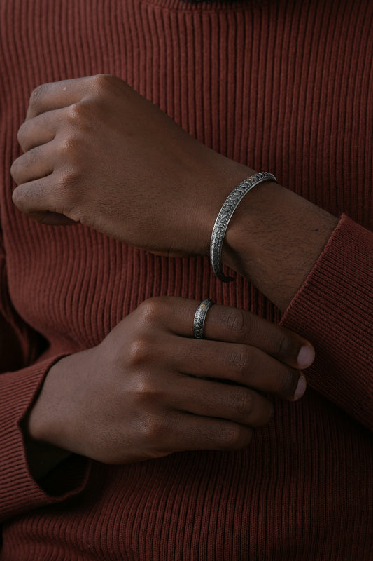 a woman wearing a red sweater and a silver bracelet