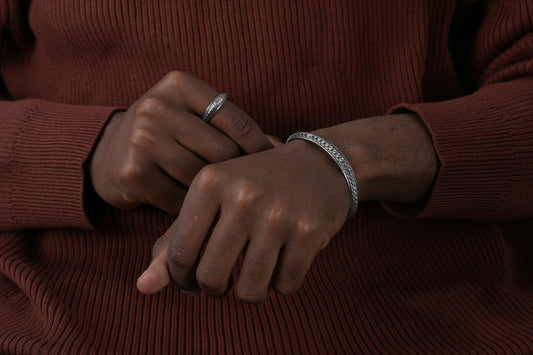 a person wearing a ring and a sweater