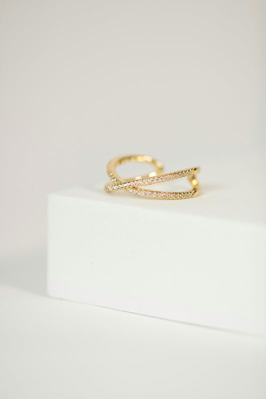 a gold ring with a diamond set on top of it