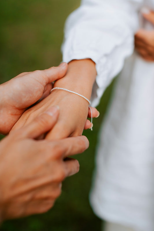 a close up of two people holding hands