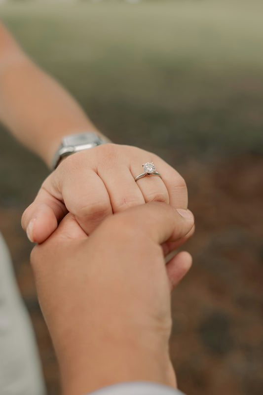 a close up of a person holding the hand of another person