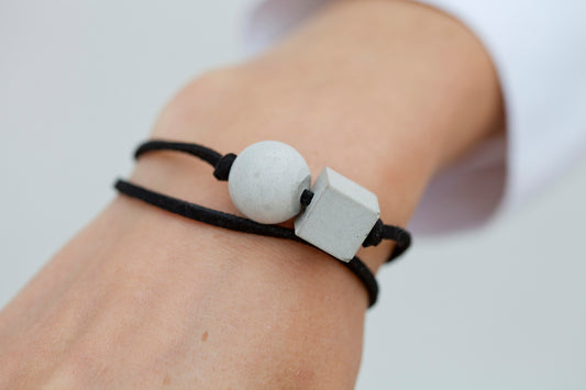 A person wearing a black and white bracelet