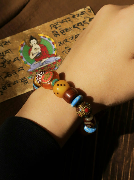 A beaded bracelet is worn, with religious art.
