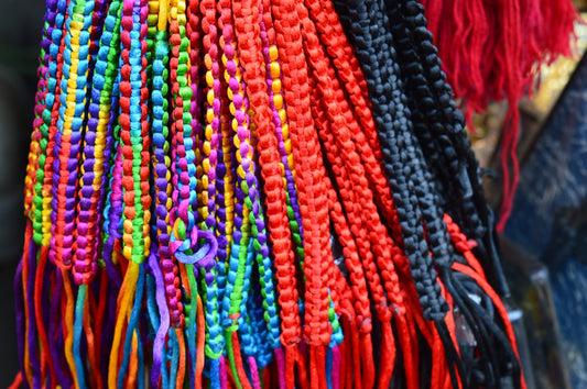 Colorful woven bracelets hanging together