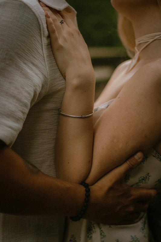 Couple embracing with arms around each other