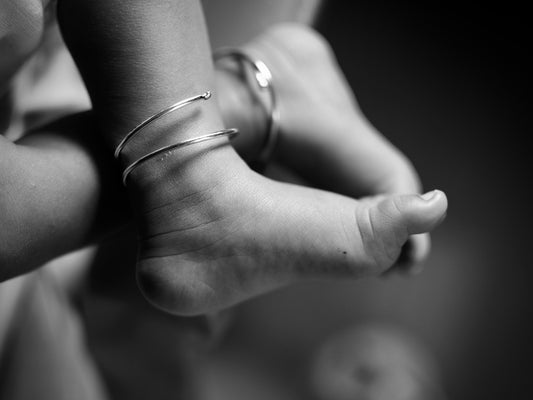 Close-up of a baby's feet wearing bracelets