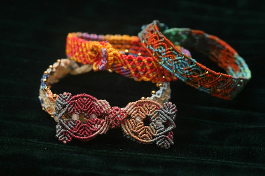 Three colorful woven bracelets with beads