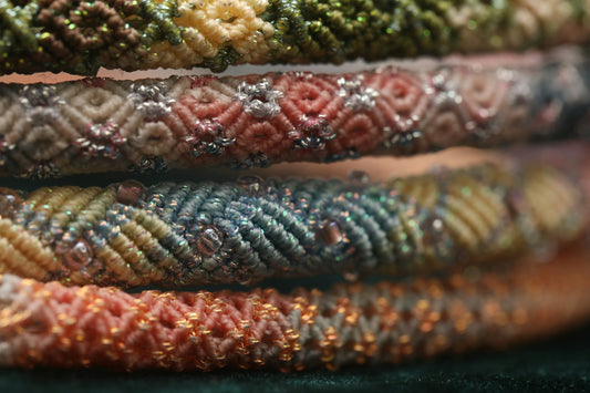 Stack of colorful beaded bracelets with intricate patterns
