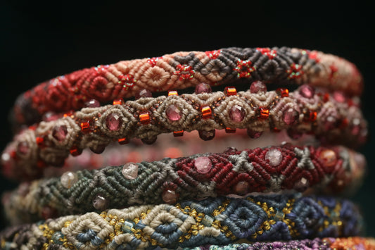 Stack of handmade beaded bracelets with intricate patterns