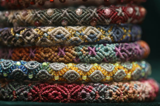 Stack of colorful woven bracelets with beads