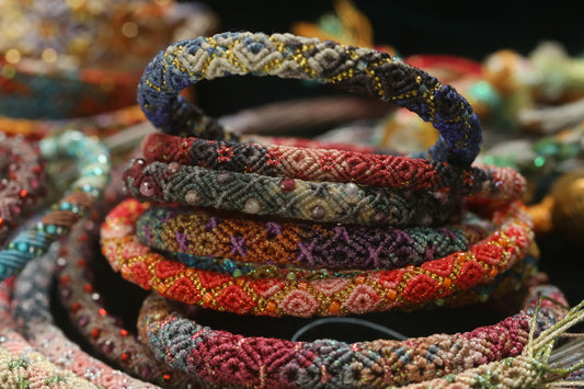 Stack of colorful beaded bracelets with intricate patterns