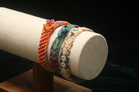 Colorful woven bracelets displayed on a stand
