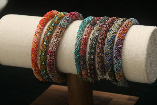 Assortment of colorful beaded bracelets displayed on stand