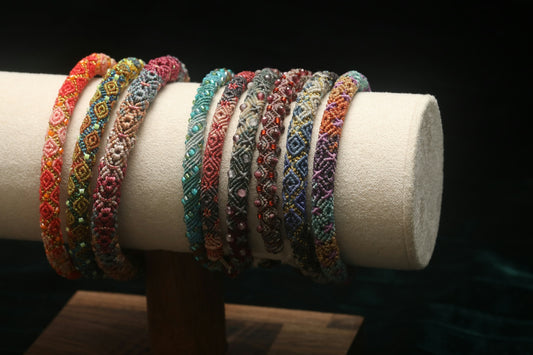 Colorful beaded bracelets arranged on a display stand