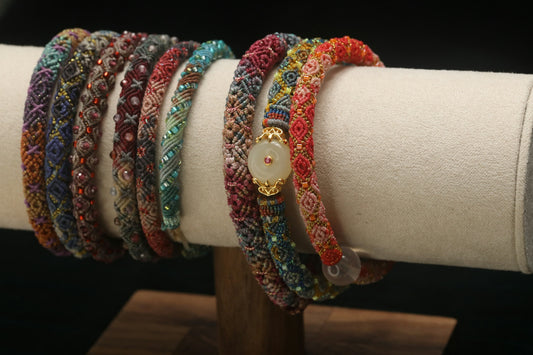 Colorful beaded bracelets displayed on a stand