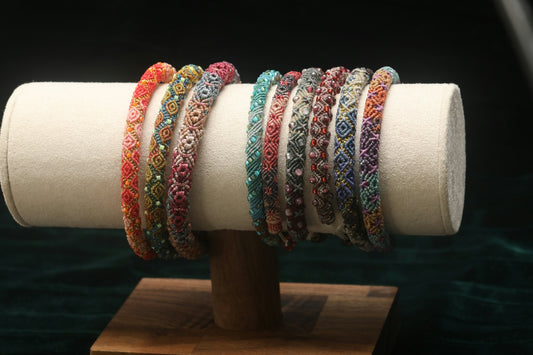 Colorful beaded bracelets displayed on a stand