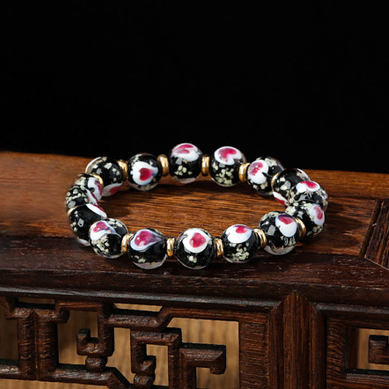 Pulsera de cuentas de vidrio fluorescentes Liuli con corazón de amor rosa y piedras de Buda doradas.