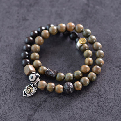 Pulsera de doble vuelta con cuentas Dzi de tres ojos de madera de ébano y sándalo verde tibetano con piedras de Buda y carácter Fu, equilibrio y paz.